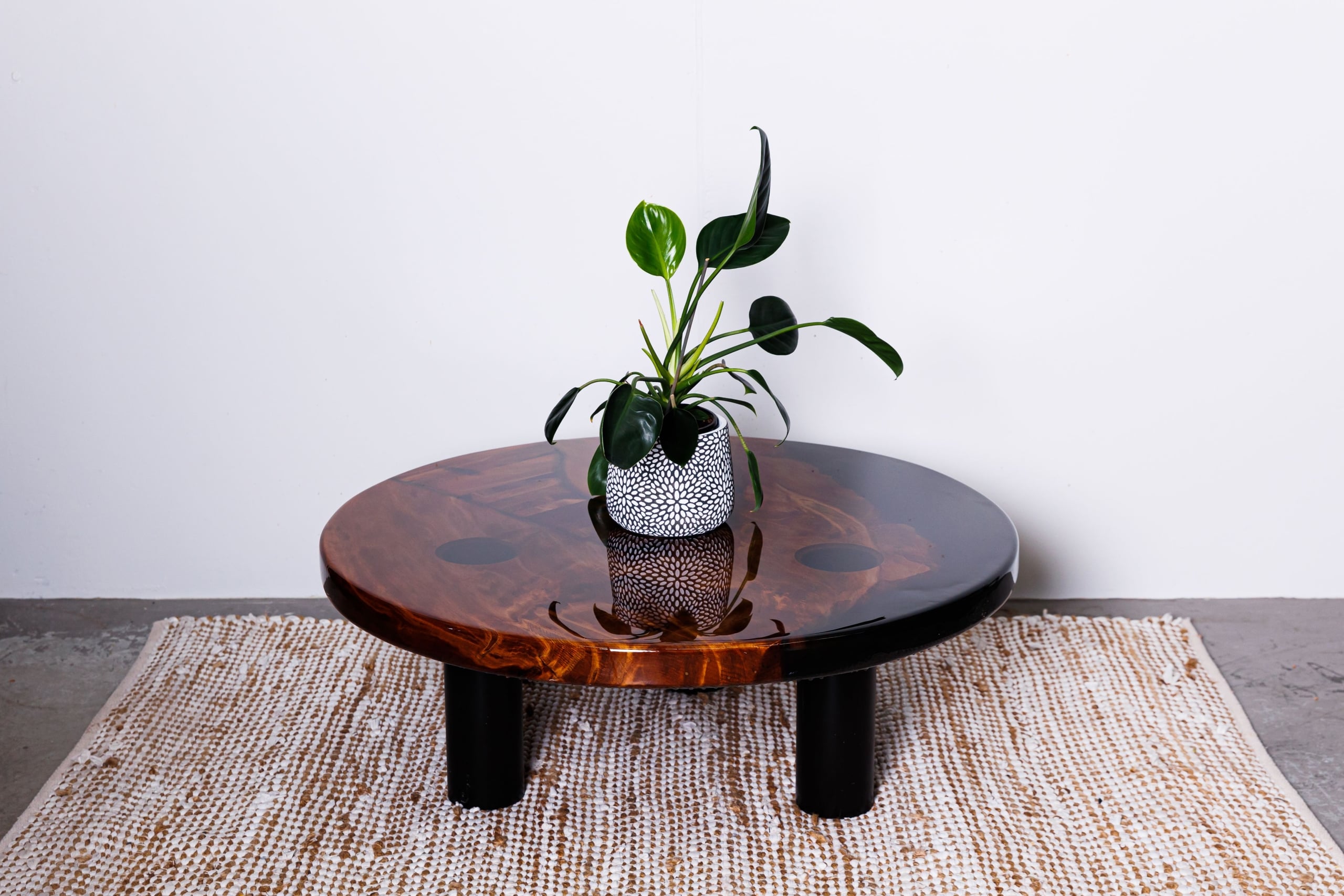 Round swamp kauri coffee table with black resin and black legs
