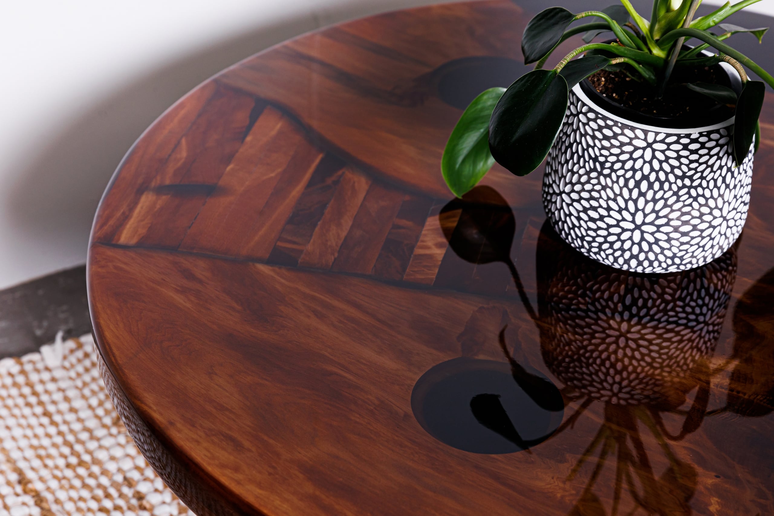 Close-up of a round swamp kauri coffee table with black resin inlays