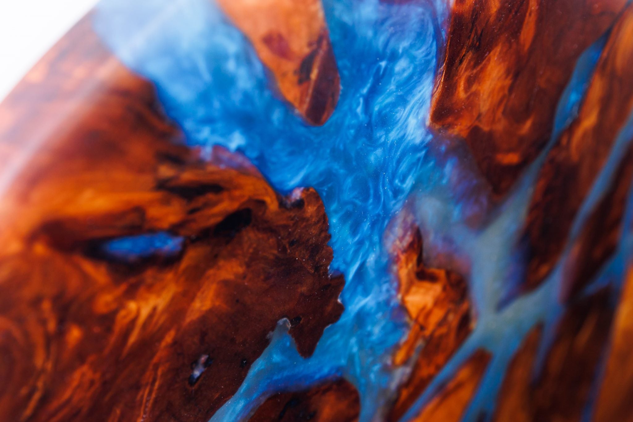 Close-up of swamp kauri grain with blue glitter resin