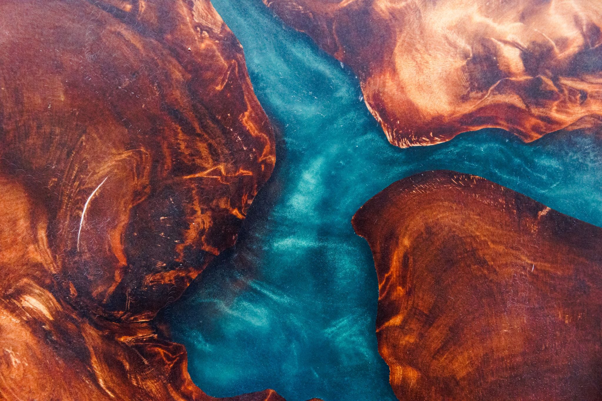Close-up of a teal resin river through swamp kauri