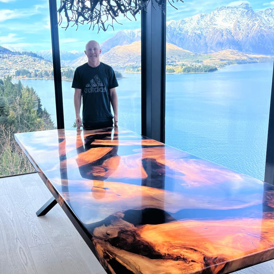 Russell Parker with a swamp kauri and resin dining table in Queenstown