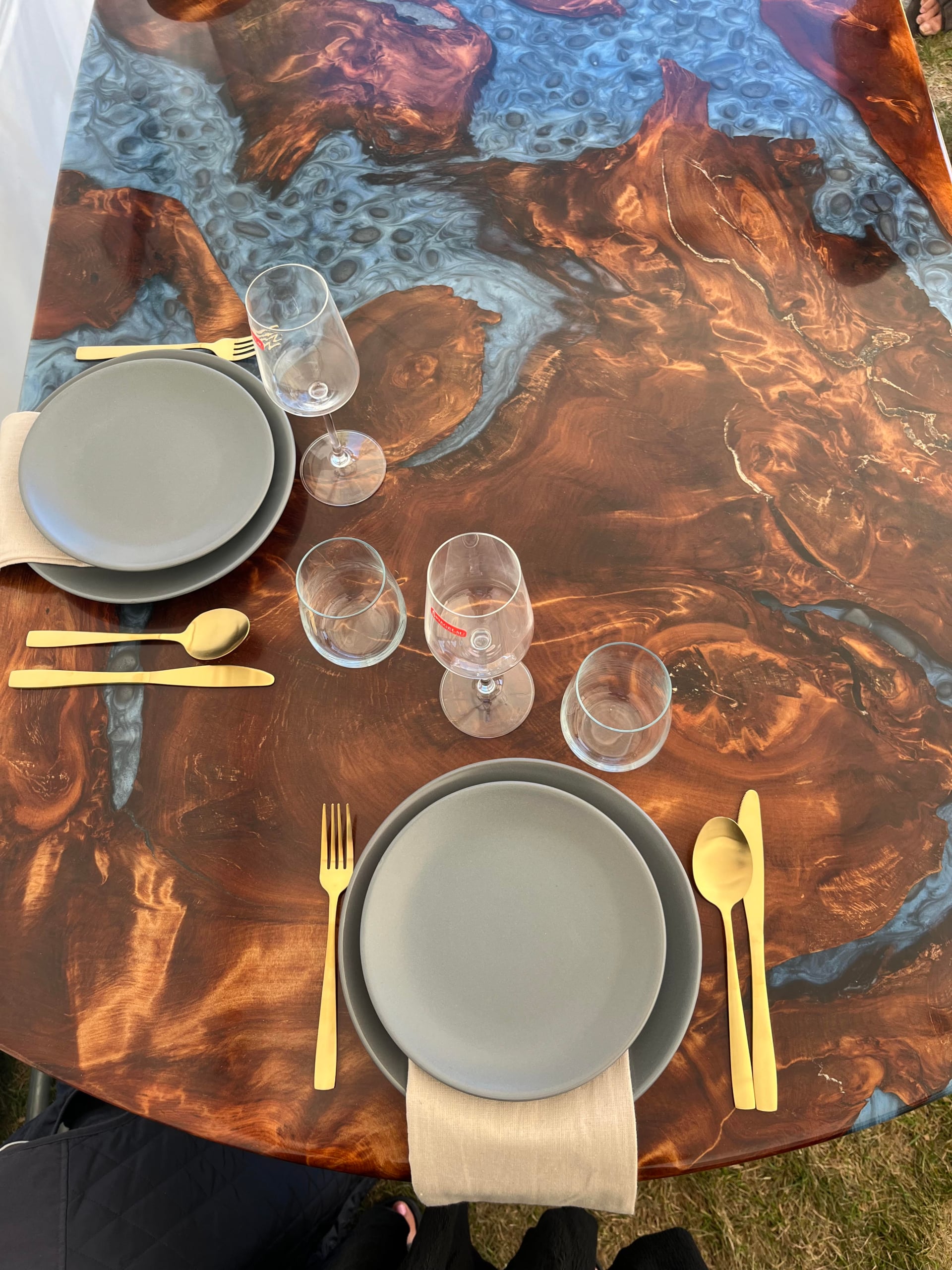 Top view of a swamp kauri and metallic blue resin dining table set for two